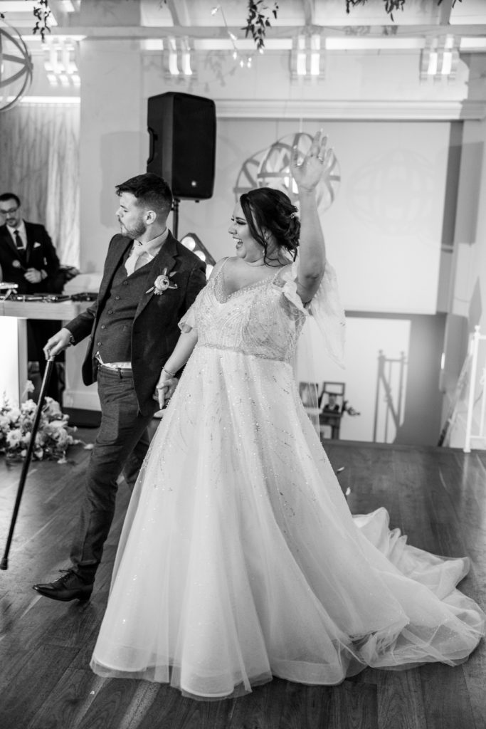 Bride and groom get on the dance floor at wedding reception holding hands for philadelphia wedding photographer