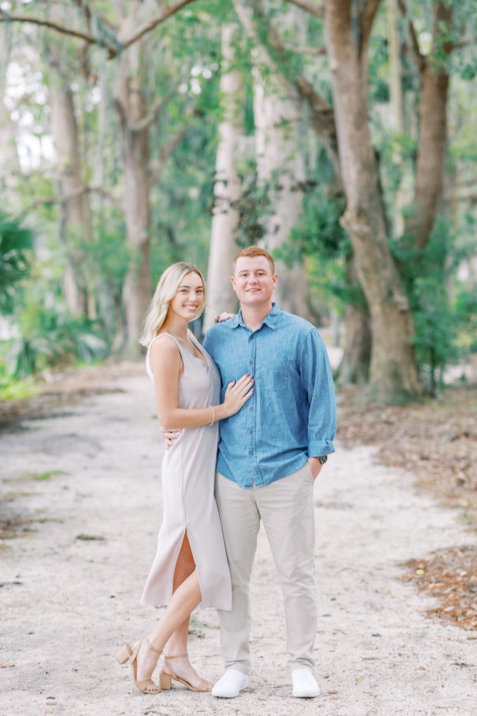 couple smiles happily for composed engagement portrait
