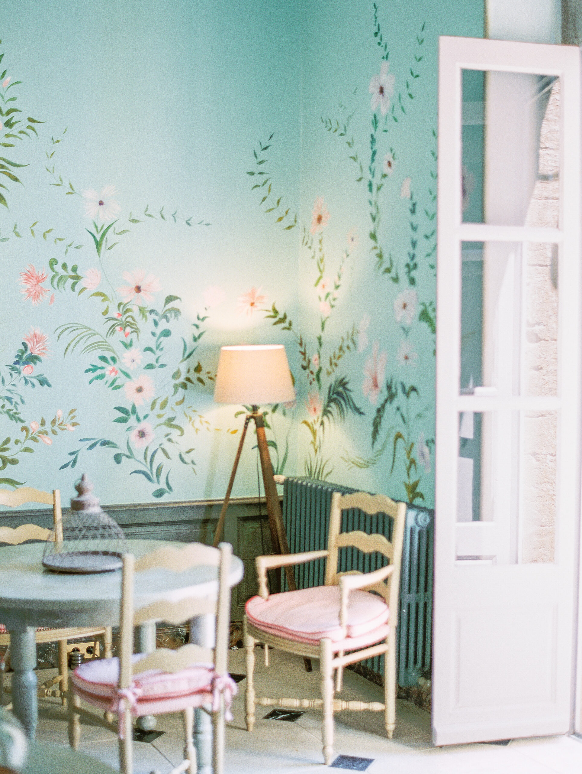 chateau de varenne breakfast room with blue walls and handpainted floral mural