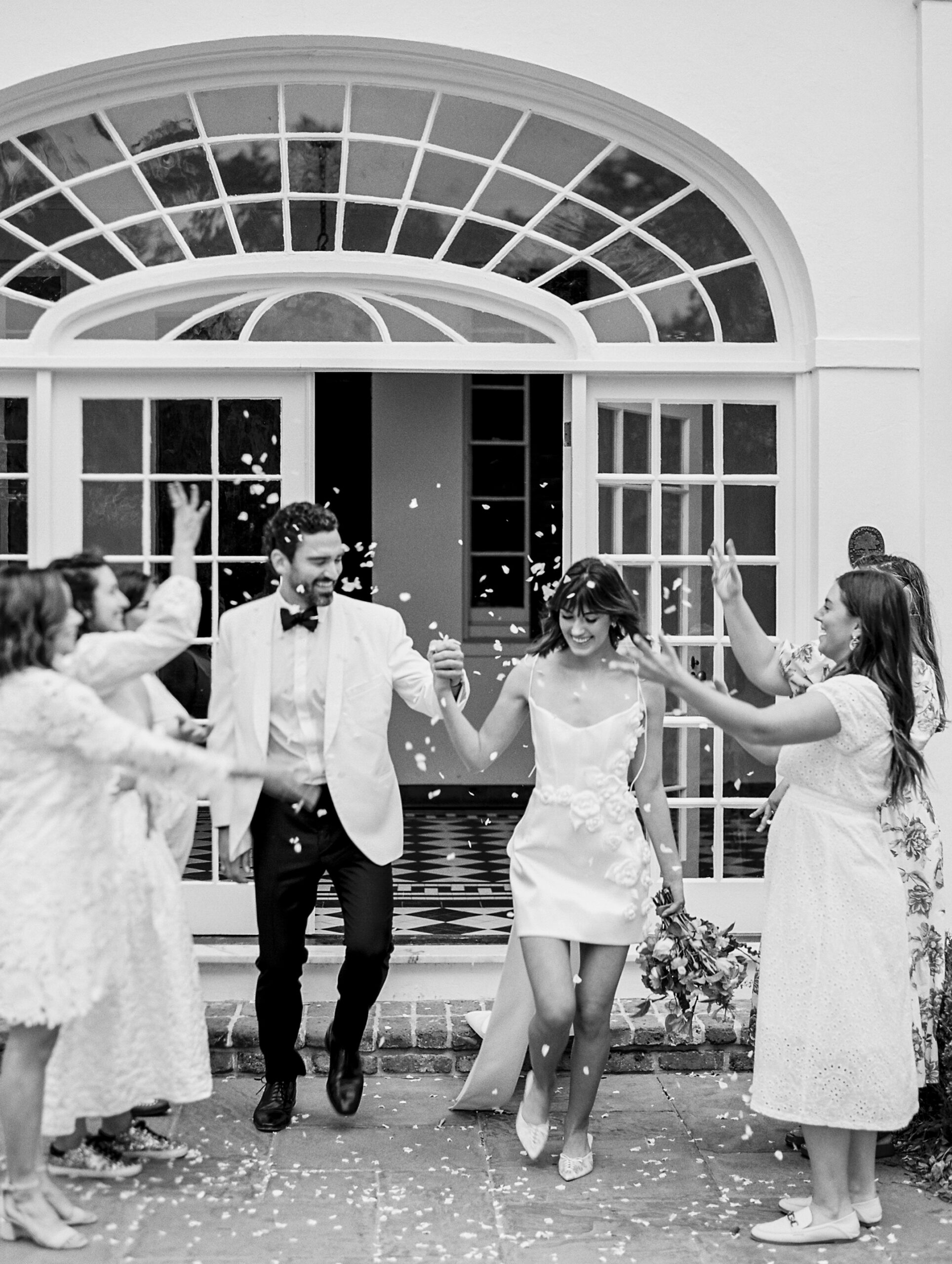 Lowdnes Grove Wedding by destination film wedding photographer Katie Trauffer Photography - bride and groom exit with petal toss