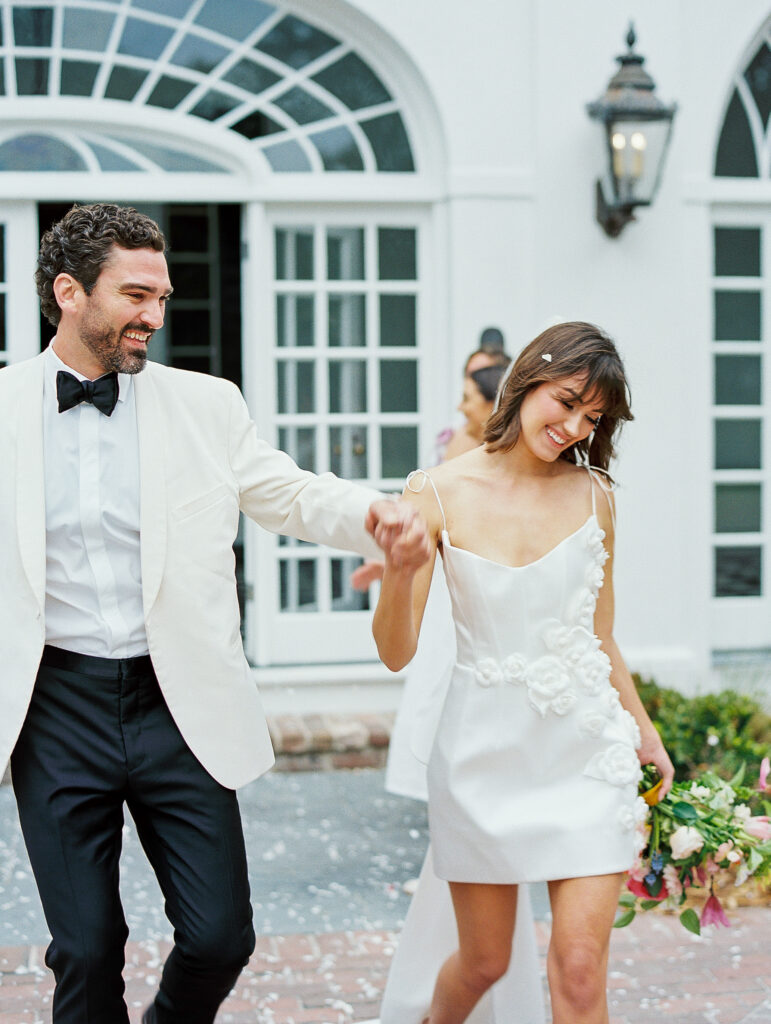 Bride and groom exit luxury charleston wedding with petal toss