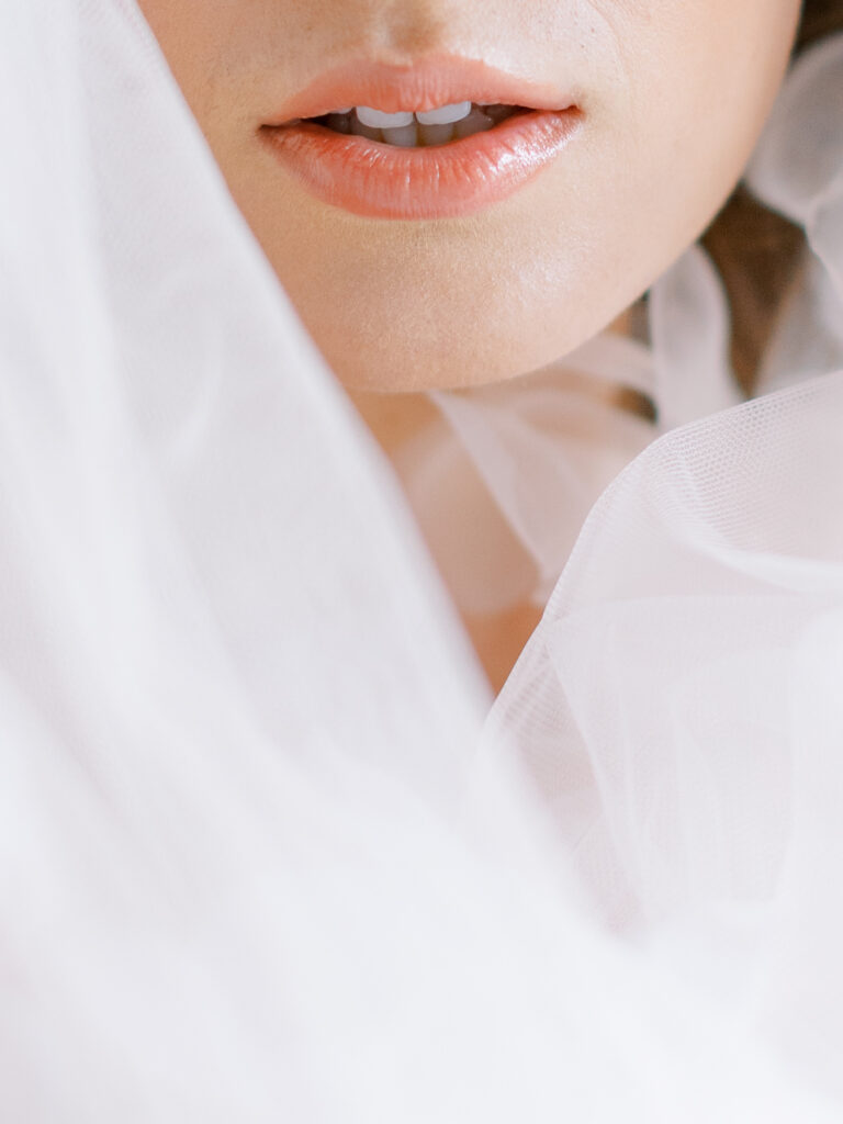 Lowdnes Grove Wedding by destination film wedding photographer Katie Trauffer Photography - bridal portrait close up detail of lips among ruffled veil