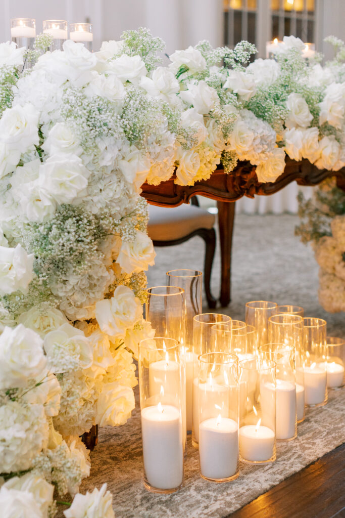 Timeless Park Chateau Wedding by Destination Film Wedding Photographer Katie Trauffer candles glow under flower covered sweetheart table