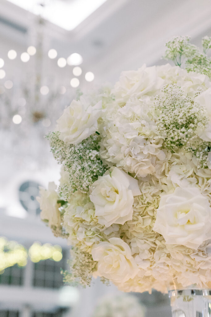 white roses hydrangeas and baby's breath wedding floral arrangement