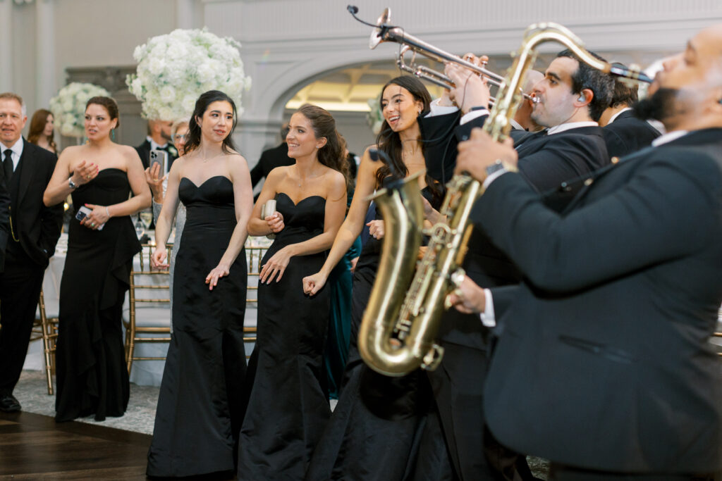 wedding band plays gold instruments on dance floor