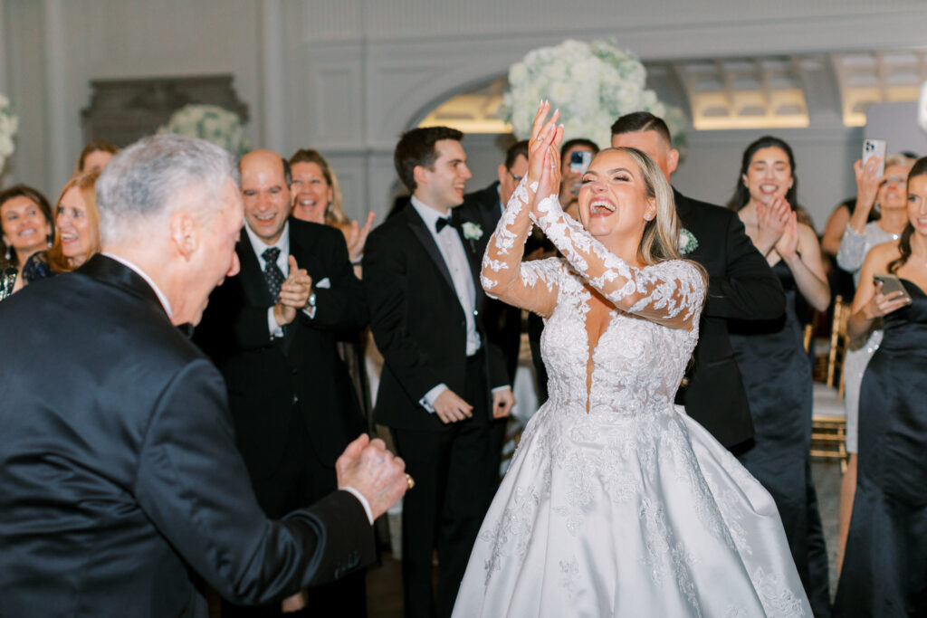 bride dances joyfully in the center of the dancefloor