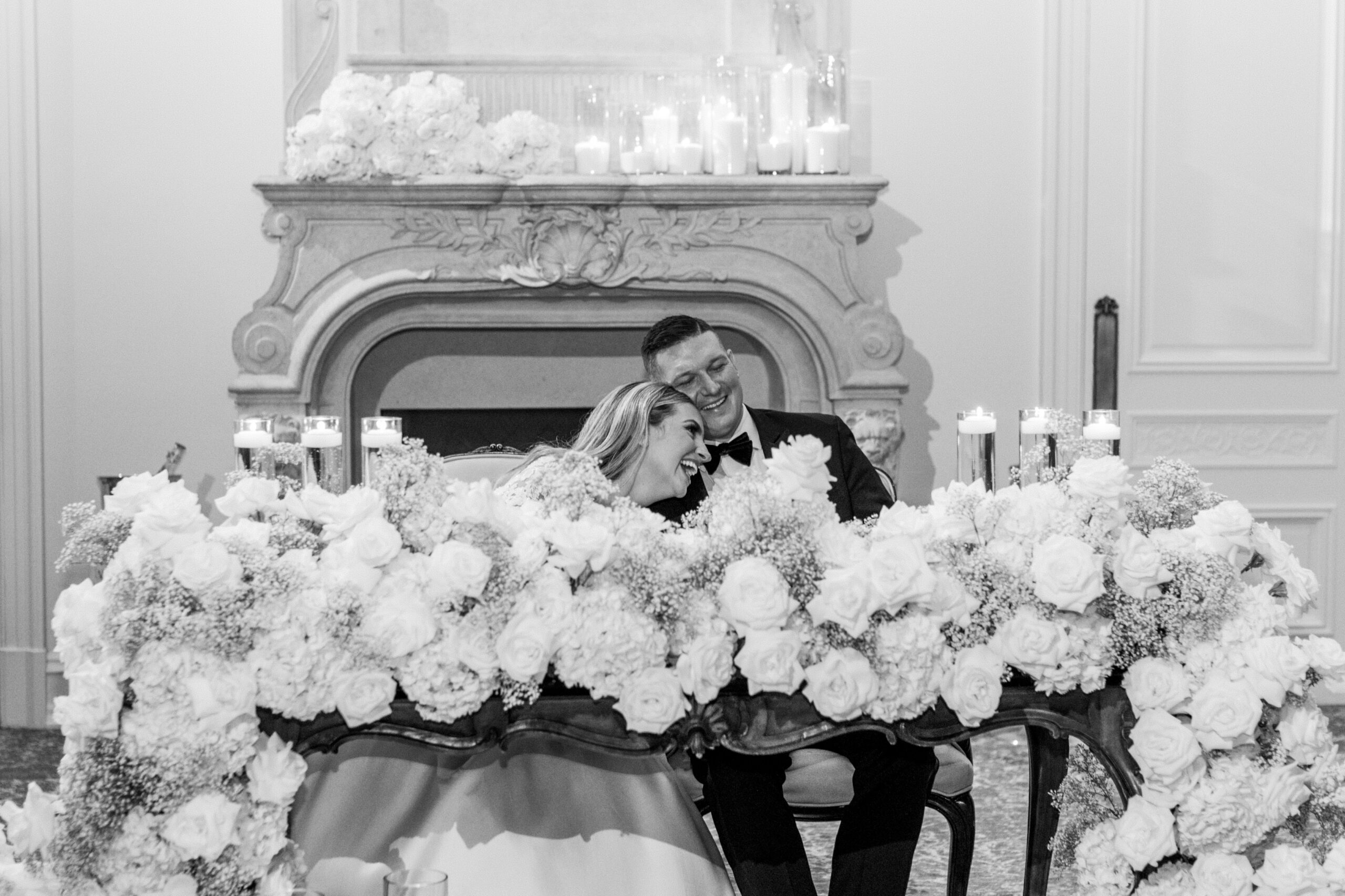Timeless Park Chateau Wedding by Destination Film Wedding Photographer Katie Trauffer bride and groom laugh at flower covered table