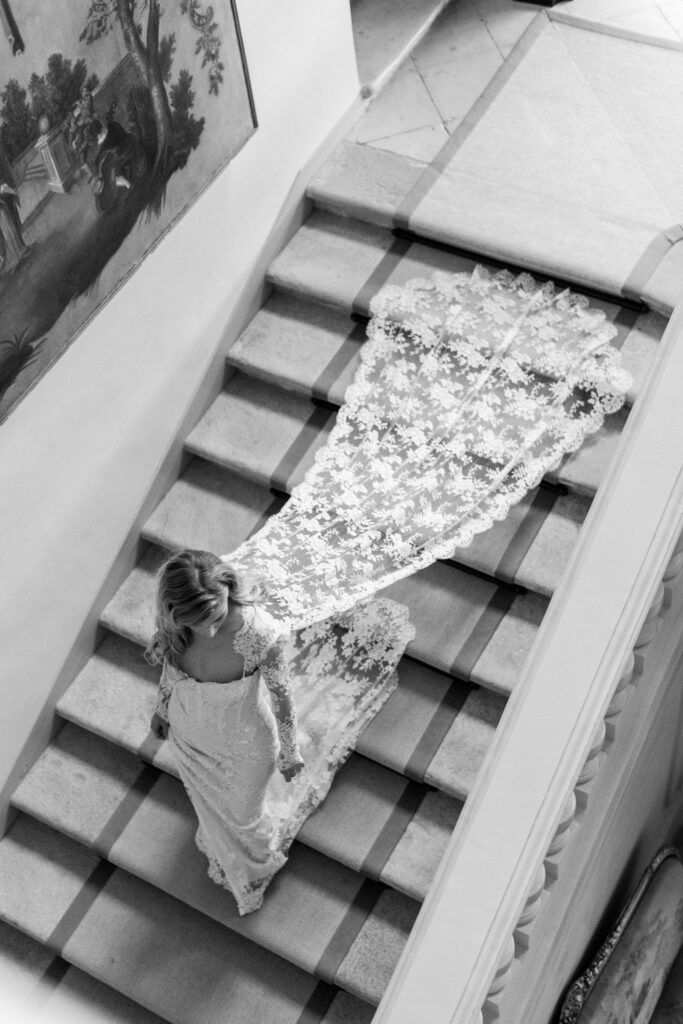 bride walks down stairs at Chateau du Grand Luce wedding