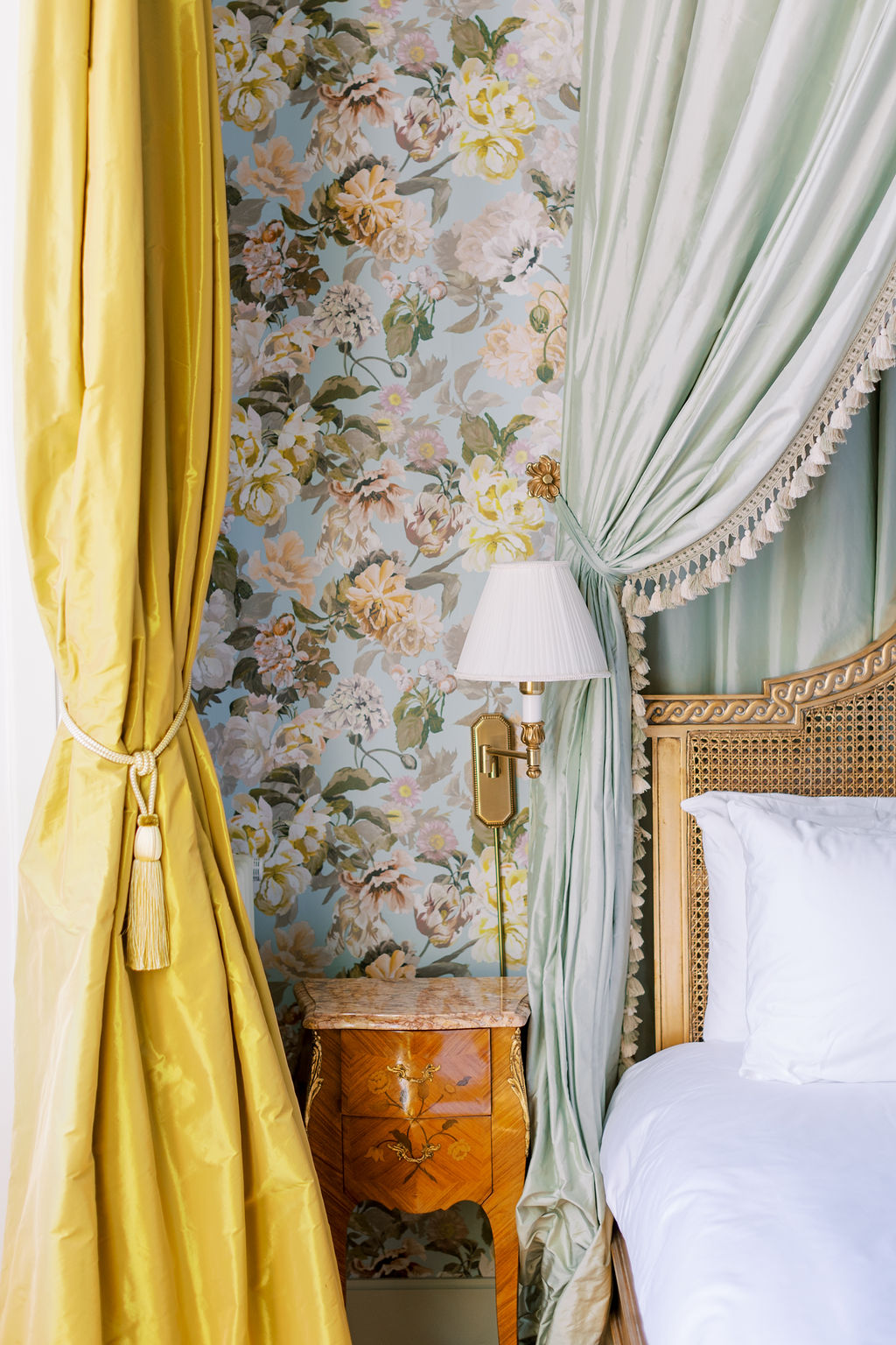 floral wallpaper with luxurious green and gold bed at Chateau du Grand Luce 