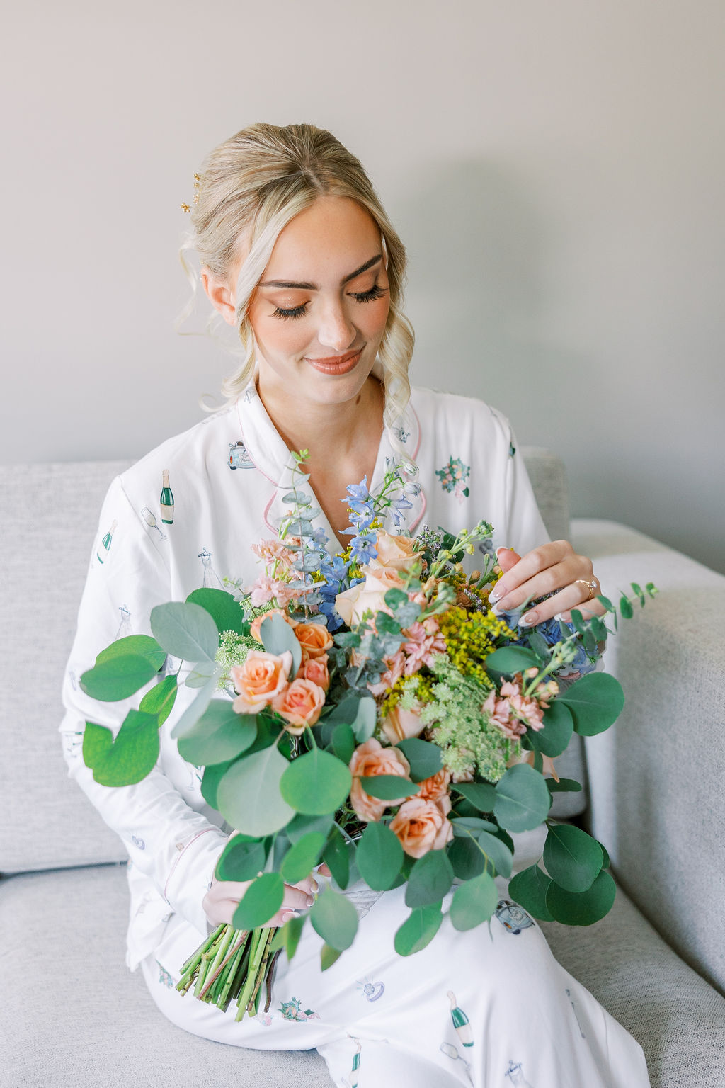 Bride admires flowers on wedding day