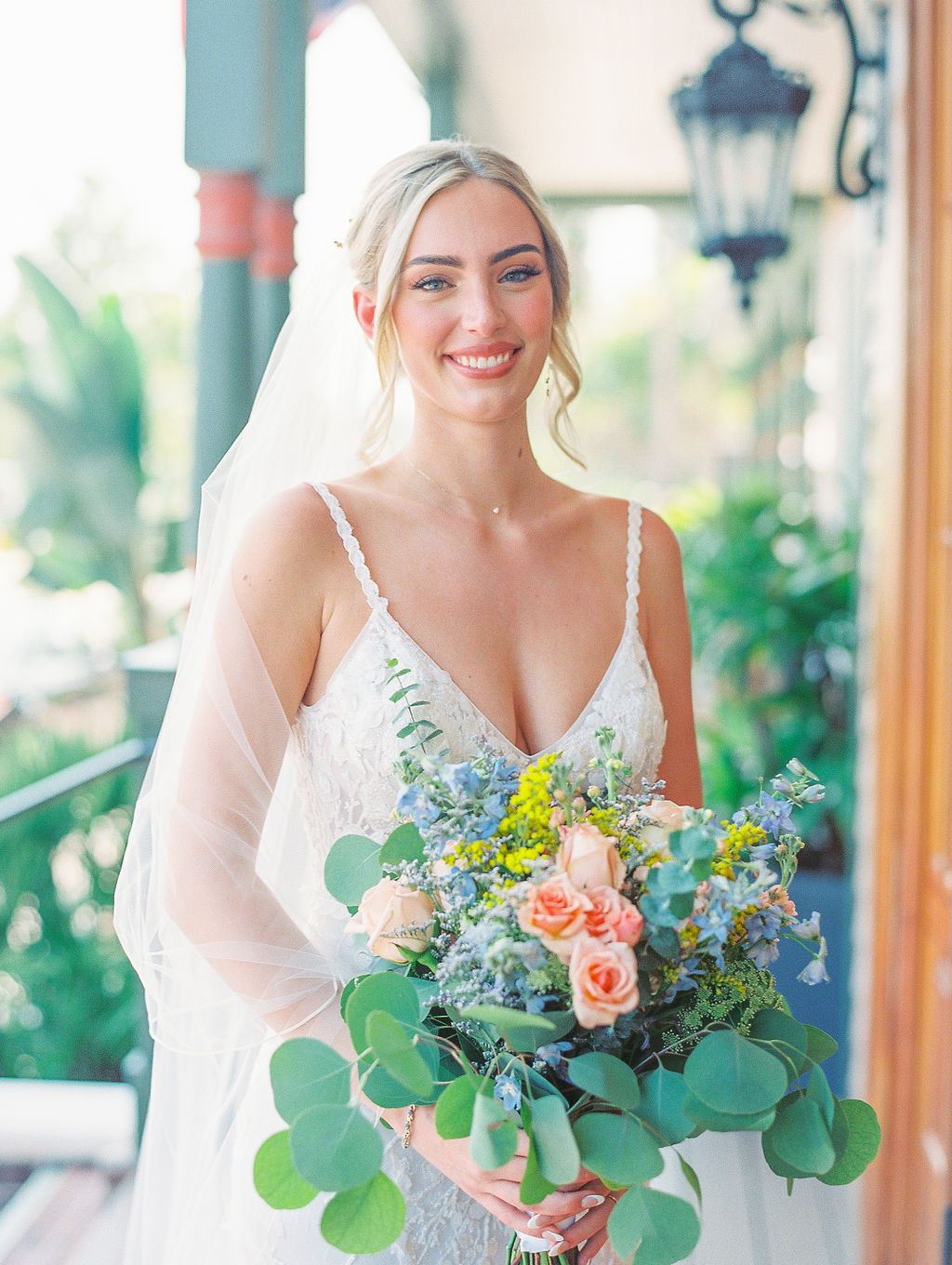 joyful bride at St Augustine Wedding with colorful flowers