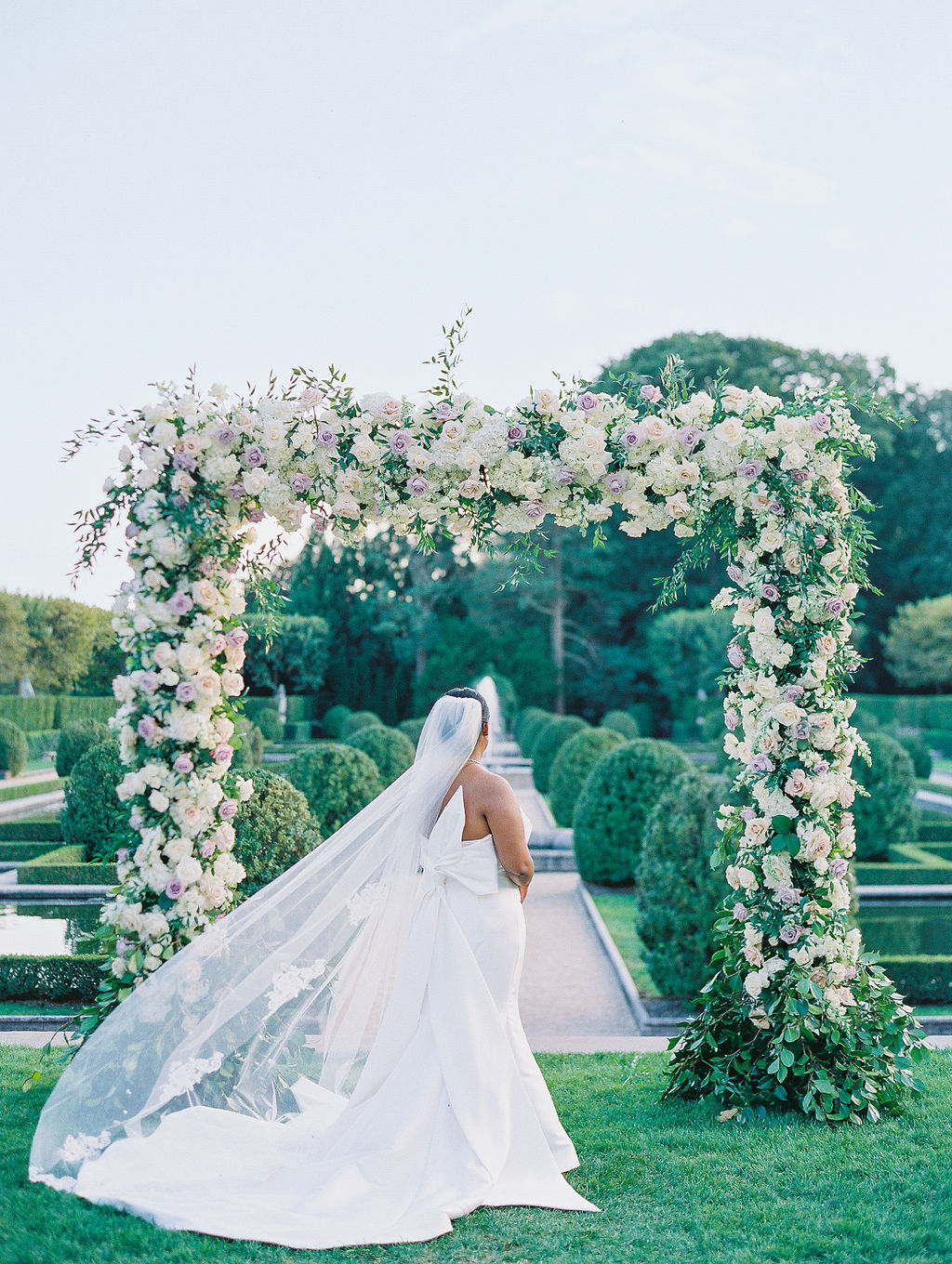 Oheka Castle Wedding Photography bridal portrait in the garden with large lush floral installation