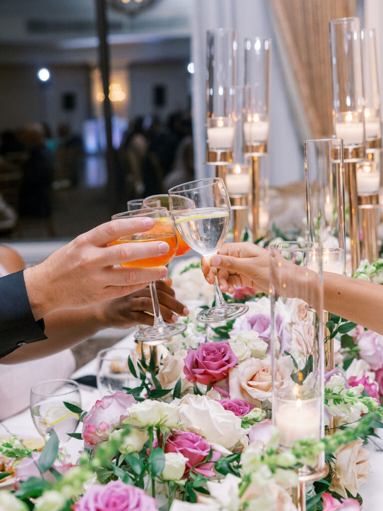 guests cheers drinks over cascading lavender blush and cream roses