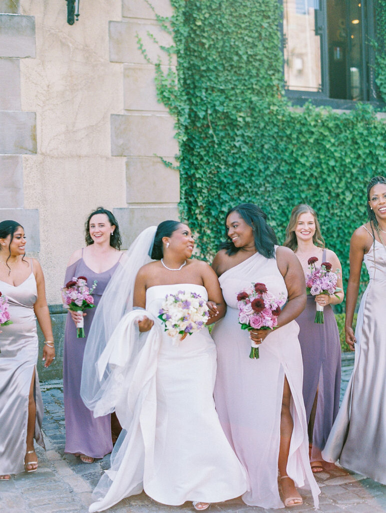 Oheka Castle Wedding Photography bride with. bridesmaids in front of ivy covered wall