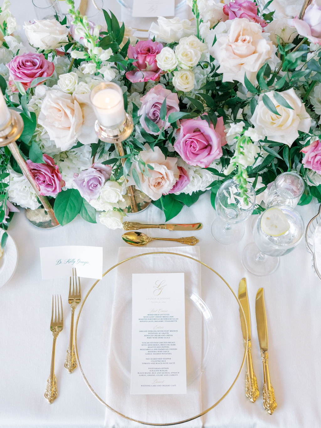 Oheka Castle Wedding Photography reception table covered in roses with clear gold chargers and ornate gold flatware